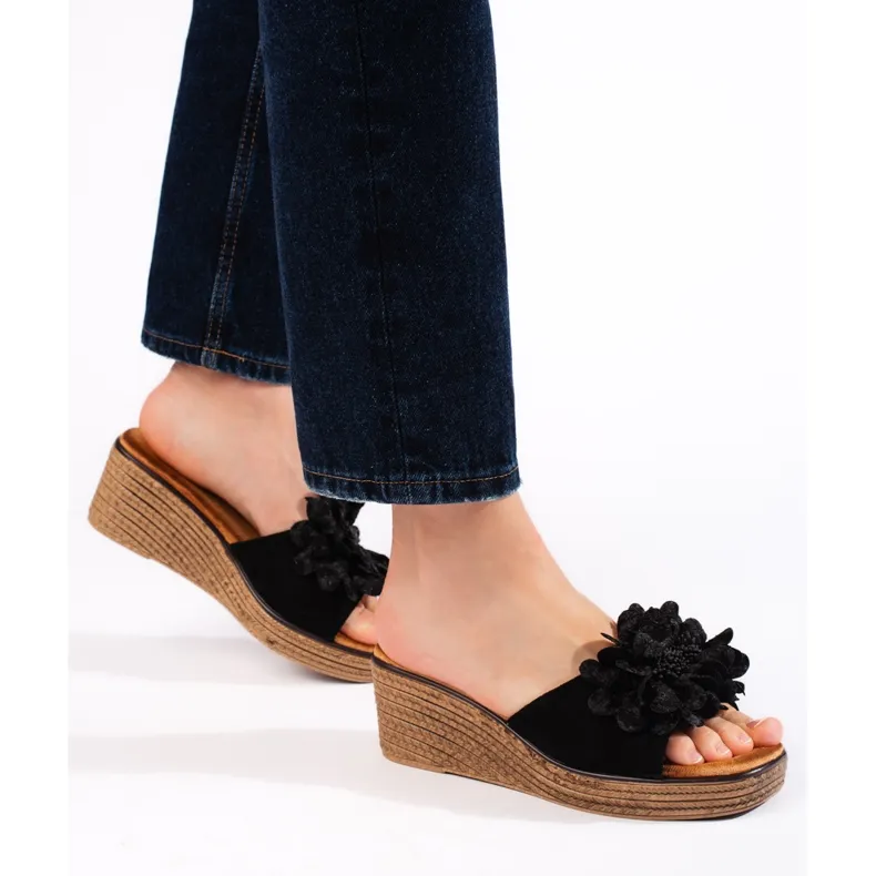 Black suede wedge mules.