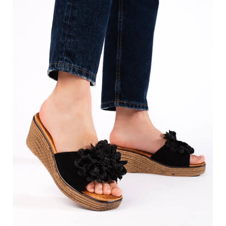 Black suede wedge mules.