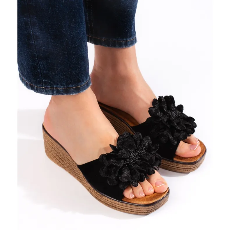 Black suede wedge mules.