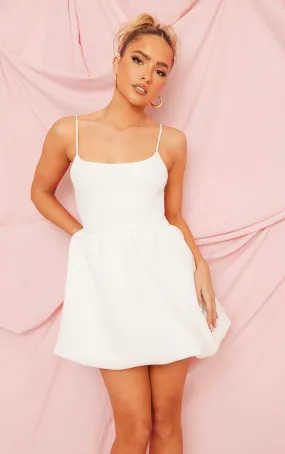 White neoprene dress with thin straps and puffy skirt: **Shop Now**