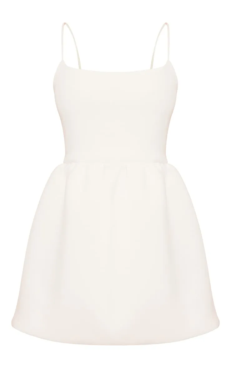 White neoprene dress with thin straps and puffy skirt: **Shop Now**